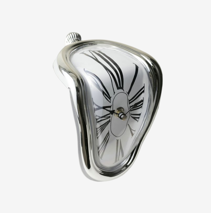 Silver surrealist melting clock resting on the edge of a metal bookshelf next to books