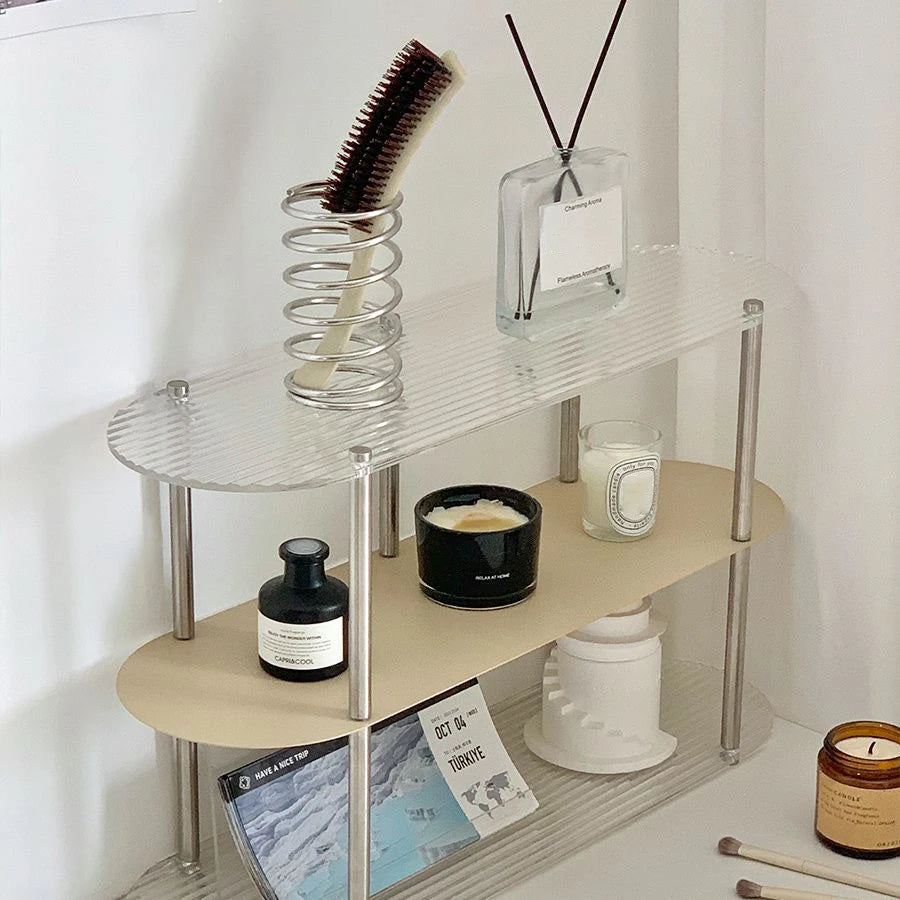 Silver chrome spiral toothbrush holder on white bathroom sink with luxury toothpaste